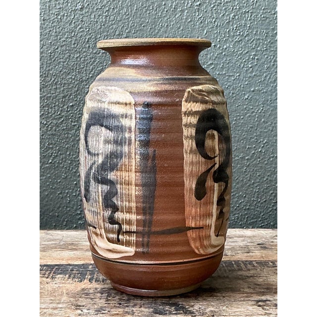 This vintage handcrafted ceramic vase beautifully exemplifies the expressive simplicity of Mid-Century Modern studio...