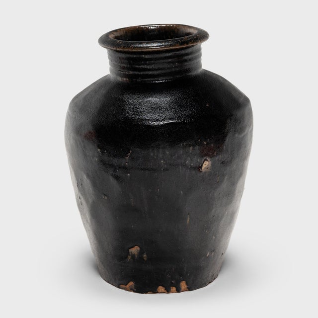 Originally used for fermenting rice or sorghum into vinegar, this earthenware vessel from the early 20th century is coated...