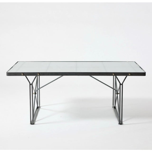 Designed by Niels Gammelgaard for IKEA in 1985, the Moment coffee table features a minimalist steel rod frame paired with...