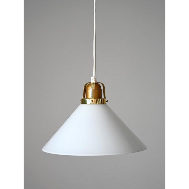 Vintage lamp in opaline glass with brass and turned wood fitting. Scandinavian production from the 1950s. Scandinavian...