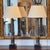 Pair of table lamps formed as fluted metal columns with alternating bronze and silvered finishes, set on square black...