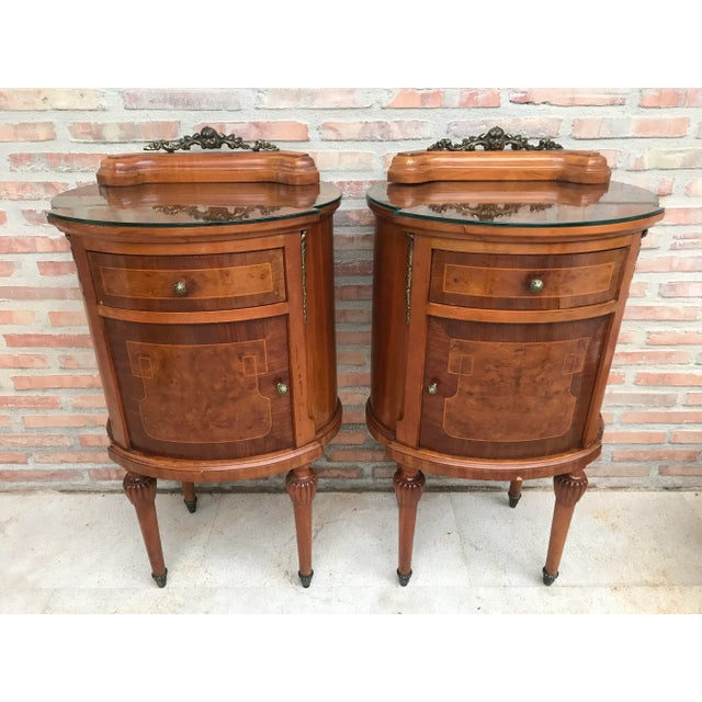 Louis xvi style pair of marquetry nightstands with metal crest one drawer and one compartment. originals handles and...
