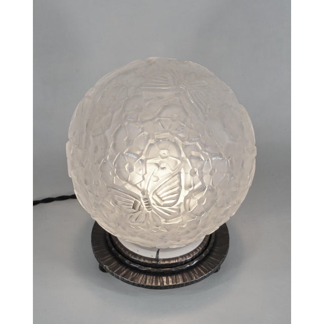 Verreries des Hanots A beautiful French art deco lamp made around 1930 in wrought iron with a globe in molded-pressed...