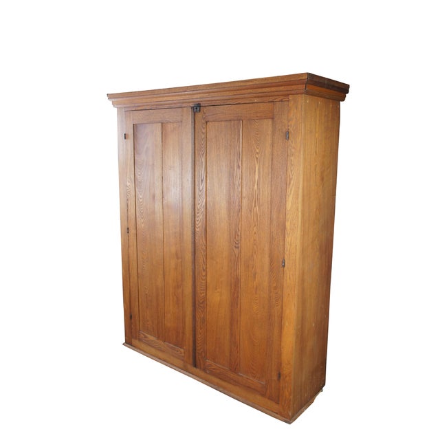 Late Victorian quartersawn oak wardrobe, armoire or linen closet. Features a larger rectangular form with split doors...