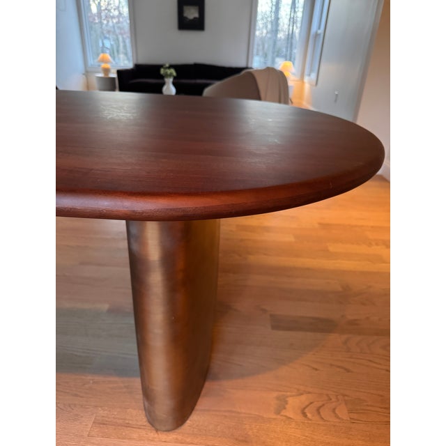 Walnut wood oval dining table with copper steel / antique brass double pedestal base . Purchased seven years ago in great...