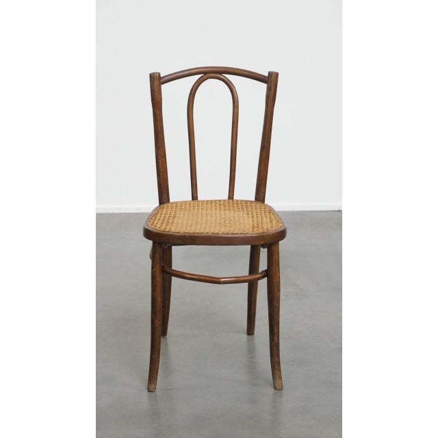 Offered this nice timeless bistro chair in the style of Thonet with a braided wicker seat. This nice bistro chair in the...