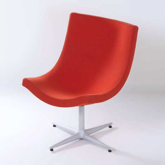 Cappellini y’s chair by christophe pillet from the 1990s, a swivel armchair upholstered in orange-red fabric. The moulded...