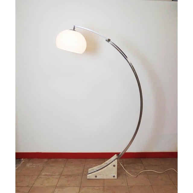 Floor lamp consisting of a base with two travertine slabs, two overlapping curved stems, the upper stem sliding on the...