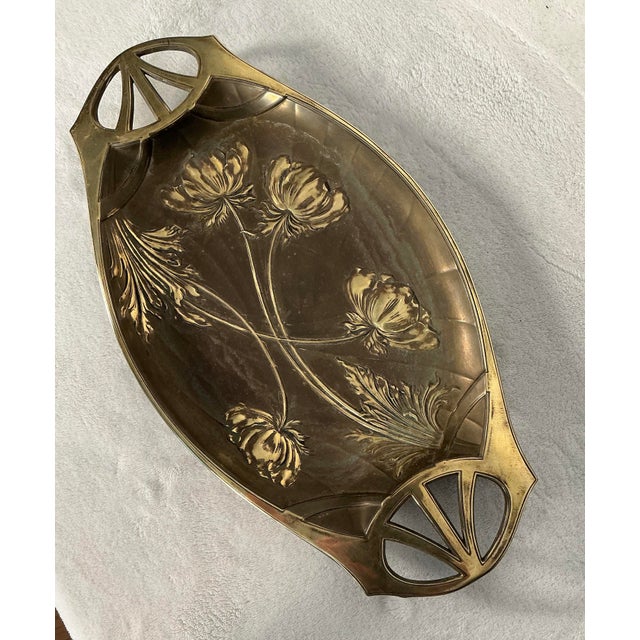 Gorgeous, authentic vintage Art Nouveau elongated oval serving tray or dish, in a heavy cast brass decorated in the center...