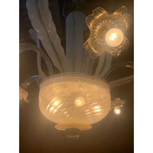 beautiful chandelier with 6 external and different lights inside the cup. it is probably a processing of the seguso...