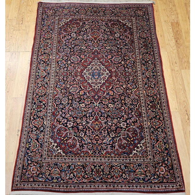 Beautiful vintage Persian Kashan area rug, meticulously hand-knotted in the early 1900s. This exquisite piece embodies the...