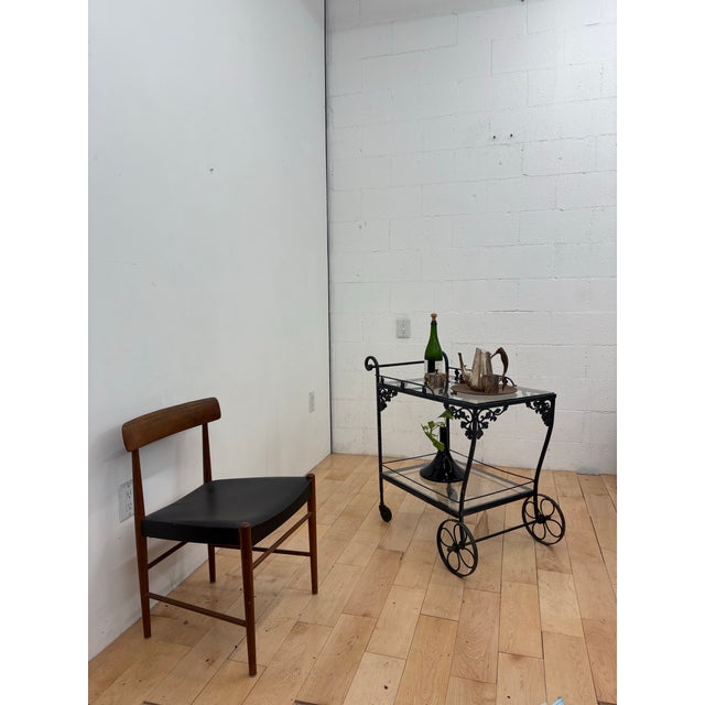 mid-century modern Russell Woodard bar / drink cart, crafted in heavy wrought iron with solid cast grape and vine...