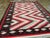 A vintage Indian Flat-weave Dhurrie carpet. A totally bold horizontal serrated zig-zag in red, black and ecru in the...