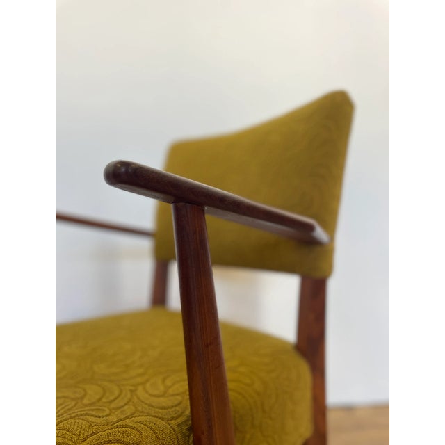 This Danish teak upholstered armchair in green fabric exudes a mid-century vintage charm. The medium wood tone, teak...