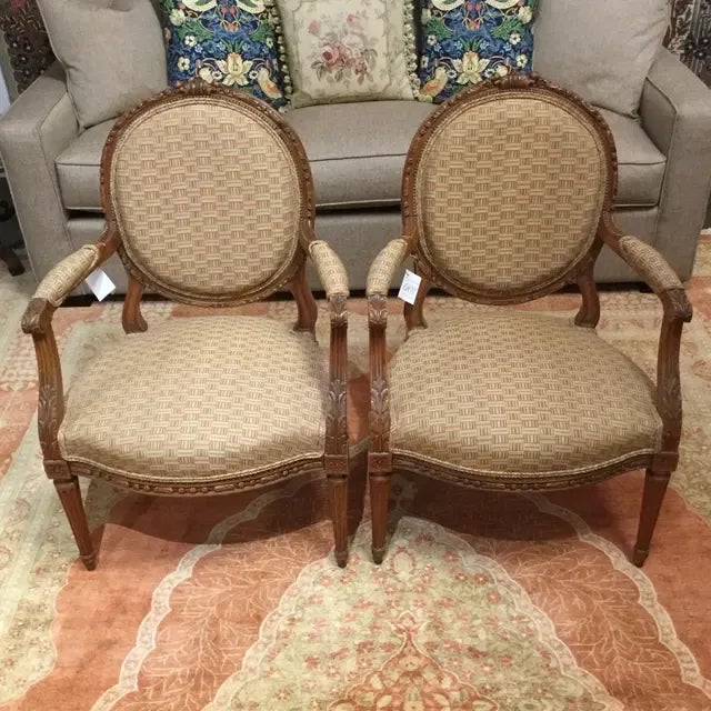 This elegant pair of antique Louis XVI style arm chairs has been re-upholstered in a celery and terracotta color basket-...