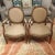 This elegant pair of antique Louis XVI style arm chairs has been re-upholstered in a celery and terracotta color basket-...