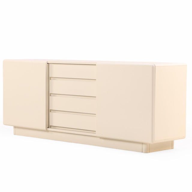 This sleek, low-profile enfilade is a striking example of Postmodern minimalism, displaying a clean, geometric silhouette...