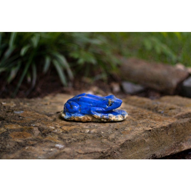 A charming hand-carved frog sculpture, executed in natural lapis lazuli of rich, saturated royal blue, accented with...