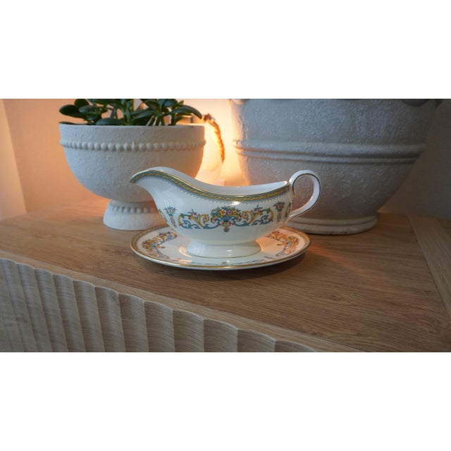 Aynsley Henley gravy boat and underplate, featuring a cream body with multicolor floral motifs, blue scrolls, and gold trim.