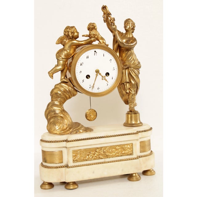 Antique French Neoclassical Clock Flanked by Figures of Venus and Cupid Atop Marble Serpentine Plinth