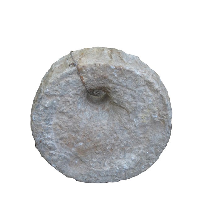 This top of a watermill stone was retrieved from the northern part of China. It was originally used for grinding grains....