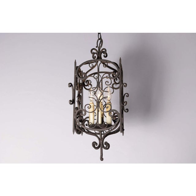 This elegant 20th-century French lantern showcases the timeless artistry of wrought iron craftsmanship. Its intricate...