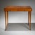 Delicate cherry wood desk with two drawers and tall, slender legs. The drawers are fitted with brass pulls. The rounded...