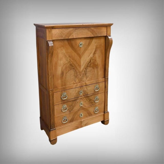 This Restoration-style secretary desk is crafted from solid walnut with a walnut veneer front. A concealed drawer is...