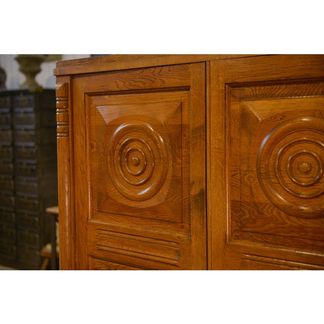 Brutalist oak wardrobe, circa 1940, with a strong sculptural presence. The double-door front is punctuated by relief...