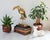 Vintage brass Tucan bird sculpture mounted on a brown wood base. Made in Korea. Minor age wear.