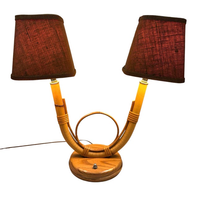 French vintage table lamp featuring two lights. Original burlap style fabric shades. Circular design in the center where...