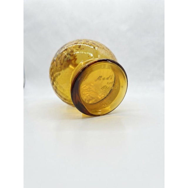 Stunning mid-century vintage amber glass decanter featuring a rich honey-gold tone, a distinct diamond optic textured...