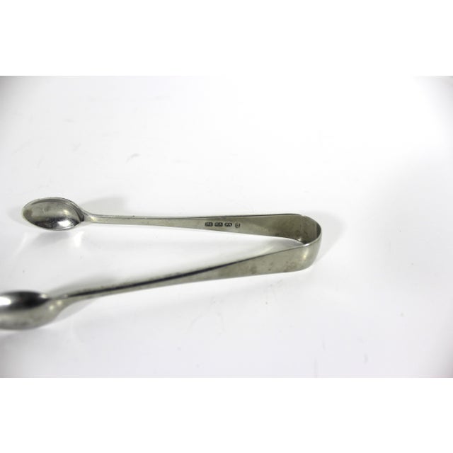 Small vintage silver plated sugar tongs. They have tarnish, scratches and patina from age and use. Nice and heavy. They...