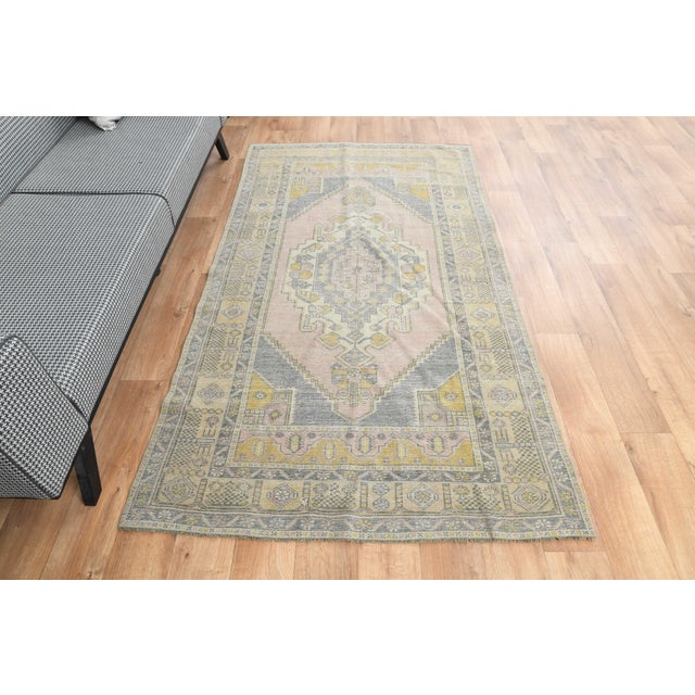 Vintage Hand-Knotted runner rug is a semi-antique vintage area rug. The '70s Eastern region of Anatolia's unique rug is...