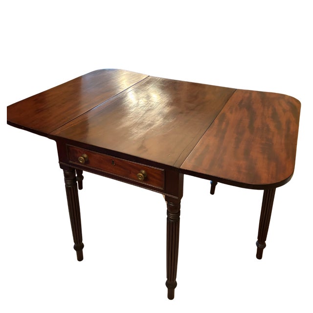 An elegant antique mahogany Pembroke table dating to the late 18th or early 19th century. This versatile table features...