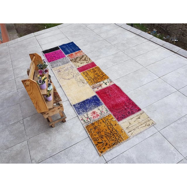 This is a vintage Turkish Oushak rug from the Mid 20th Century. The piece was hand-knotted.