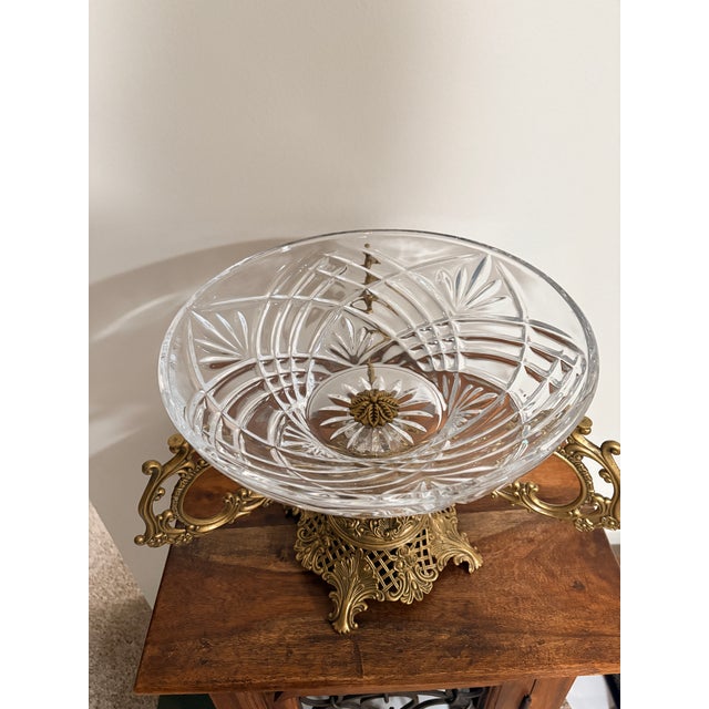 This exceptional piece features a rare trifecta of high-end materials:deeply hand-cut crystal, an ornate solid brass...