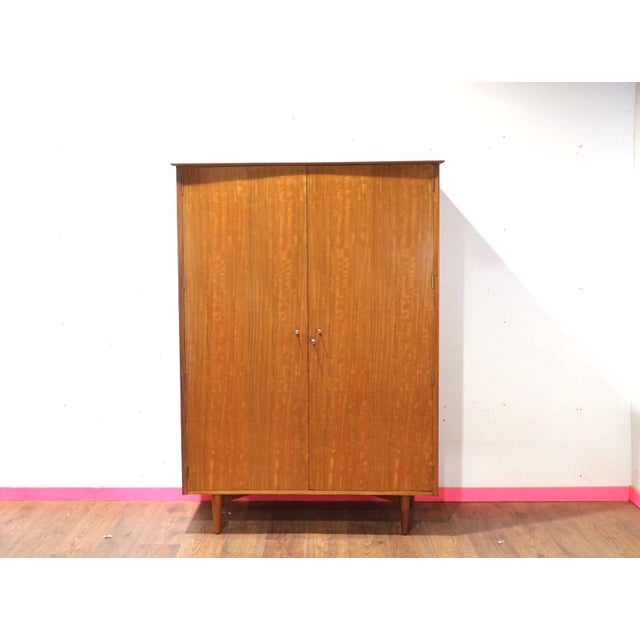 Enhance your living space with a wonderful Mid century teak armoire by Younger, brought to you by Mid Century Traders....