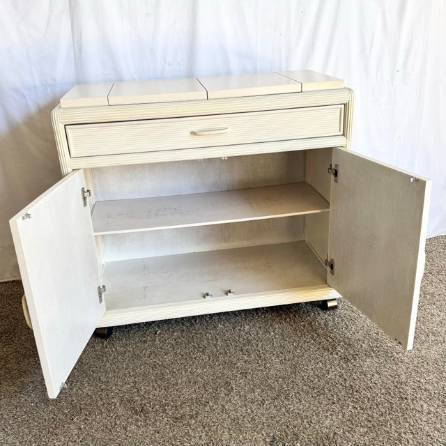 A beautifully sculptural vintage Boho Chic buffet crafted in pencil reed with a soft cream finish. The front showcases a...