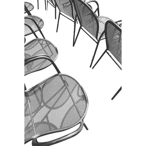 Empty wrought iron chairs in a row with shadows on the ground (Getty) As an authorized Getty Images Gallery partner, we...