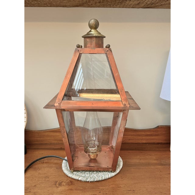 A vintage Hollis W. Fisher Edgartown lantern is a handcrafted copper-and-brass light fixture, designed as an authentic...
