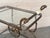 Gorgeous bronze Baroque 2 tier bar or tea cart. under the with wood shelves. Features a heavy ornate bronze frame on...