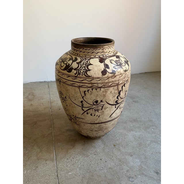 Antique Chinese pottery storage jar in the manner of Cizhou ware, likely dating to the Ming Dynasty (1368–1644). The...
