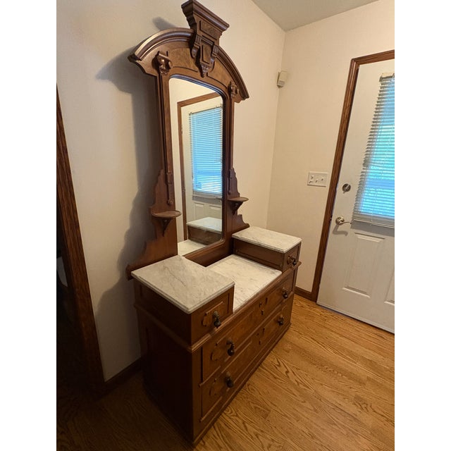 Antique Victorian Eastlake Walnut dresser. 1800's. 2 large and 2 small drawers with 3 white marble tops. Mirror in an...