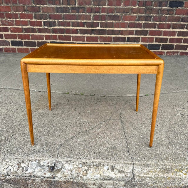 Petite T.H. Robsjohn Gibbings side table with long slender legs. This table has beautiful rounded edges that fall into the...