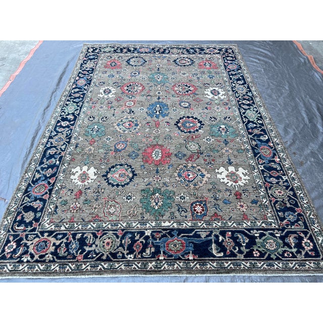 Beautiful antique Serapi style hand-knotted wool rug with a gray field. This piece has a green-designed frame and an all-...