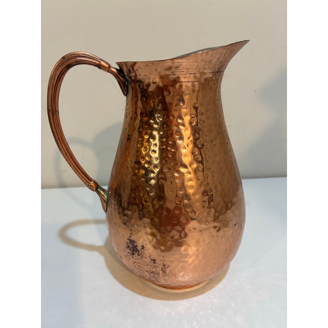 Vintage Gorham hammered copper pitcher featuring a classic bulbous silhouette with hand-hammered finish, flared pouring...