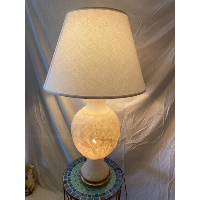 Beautiful antique table lamp carved out of alabaster with floral motif. Has one small chip you can see in the picture,...