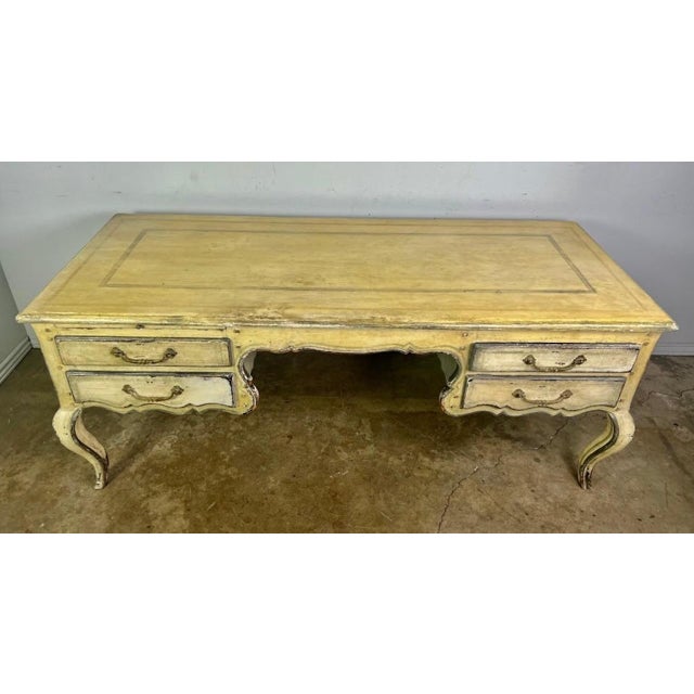 Early 20th century painted French Provincial style desk. The desk stands on four cabriole legs that end in rams head feet....