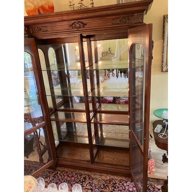 This monumental china cabinet features exceptional craftsmanship and grand, architectural scale. Constructed from rich,...